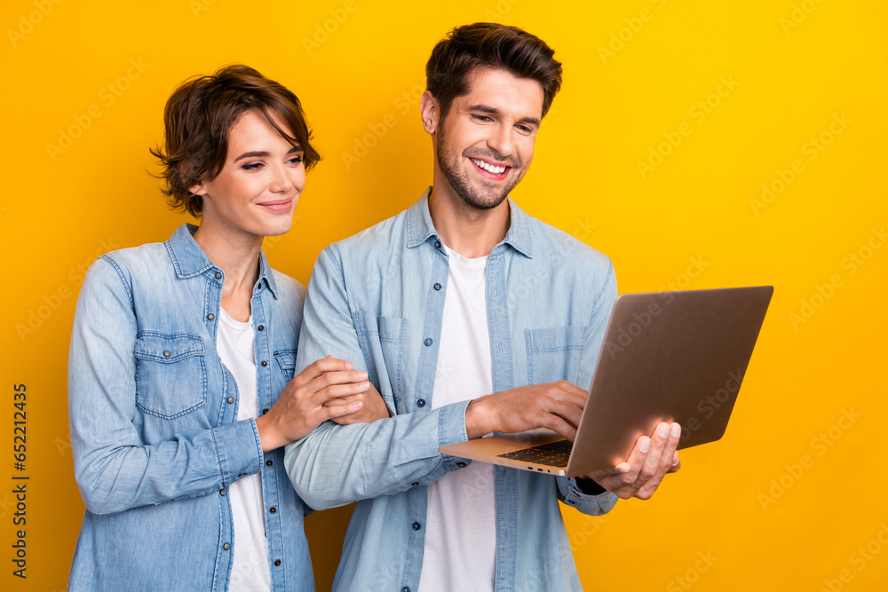 Photo of two freelancer lady guy browsing netbook chatting eshop website isolated bright color background Photo of two freelancer lady guy browsing netbook chatting eshop website isolated bright color background
