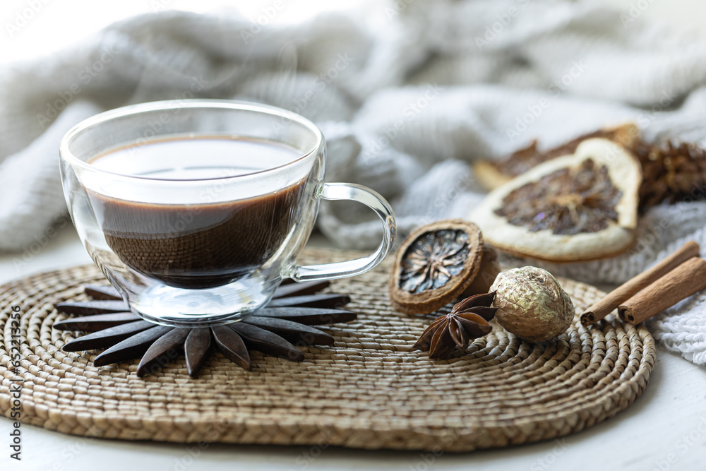Composition with a cup of coffee on a blurred background with a knitted element. Composition with a cup of coffee on a blurred background with a knitted element.