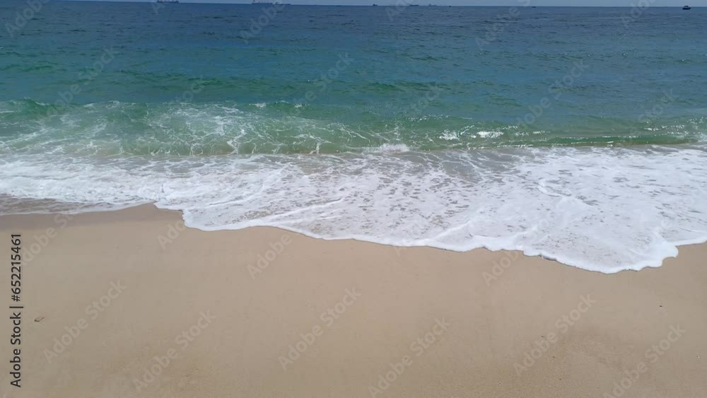 Seascape, scenery landscape, view of Ca Na beach, Ninh Thuan province, Vietnam. Sandy beach, blue sea, waves, white foam crashing over sandy seashore sunny day. Seascape, scenery landscape, view of Ca Na beach, Ninh Thuan province, Vietnam. Sandy beach, blue sea, waves, white foam crashing over sandy seashore sunny day.
