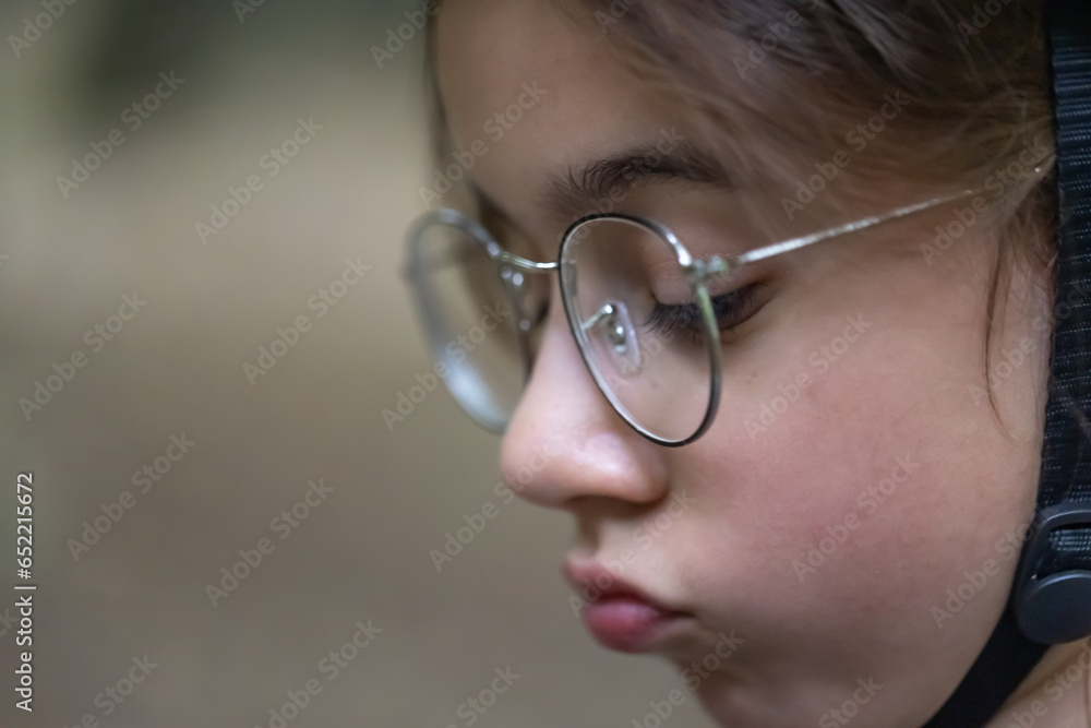 Close-up, teenage girl wearing a protective bicycle helmet. Close-up, teenage girl wearing a protective bicycle helmet.