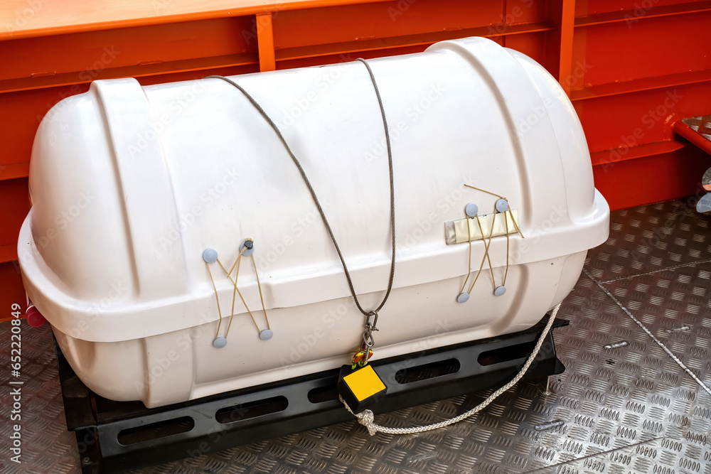 Container with inflatable boat on deck. White tank is locked. Rescue equipment on board ship. Boat deck. Lifeboat release tray. Safety measures on cruise ship. Ship equipment for emergency situations Container with inflatable boat on deck. White tank is locked. Rescue equipment on board ship. Boat deck. Lifeboat release tray. Safety measures on cruise ship. Ship equipment for emergency situations