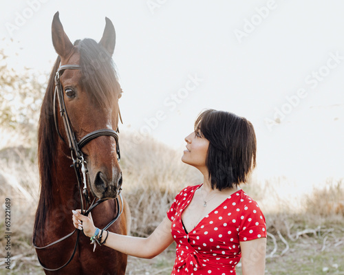 Young woman with horse on ranch