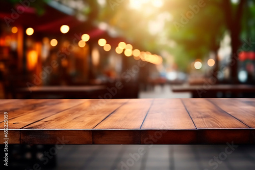 Empty wooden table in front of abstract blurred Christmas light background for product display in a coffee shop, local market or bar