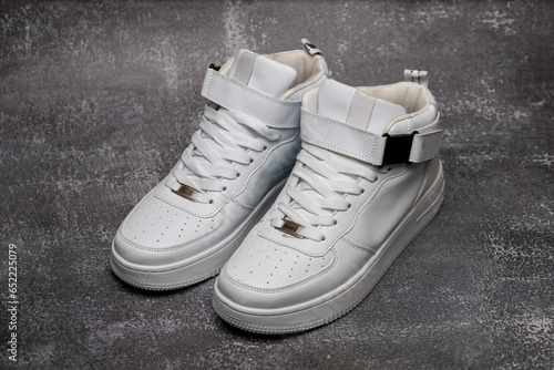 Leather white men's sneakers. Men's casual sports shoes. Fashionable sneakers.