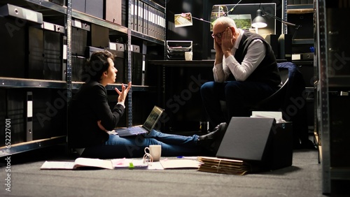 Billede på lærred Agents feeling tired of criminal case, discussing about forensic evidence authenticity to gather more incriminating proof and solve mystery