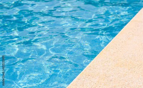 The edge of a hotel pool on a summer day. Empty space. Selective focus on the foreground. summer holiday concept