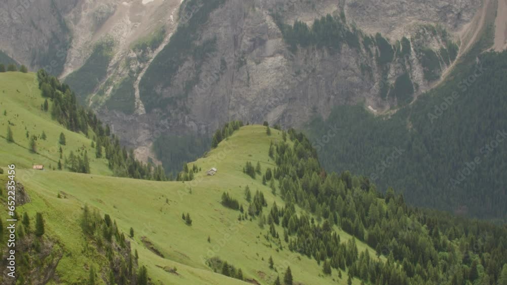 Tripod shot calm of hill bank of green grass and rocky mountain. Beautiful view of italian alps dolomites in the summer near canazei. Tripod shot calm of hill bank of green grass and rocky mountain. Beautiful view of italian alps dolomites in the summer near canazei.