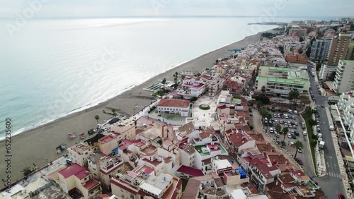 Aerial view over La Carihuela Beach approaching sea photo