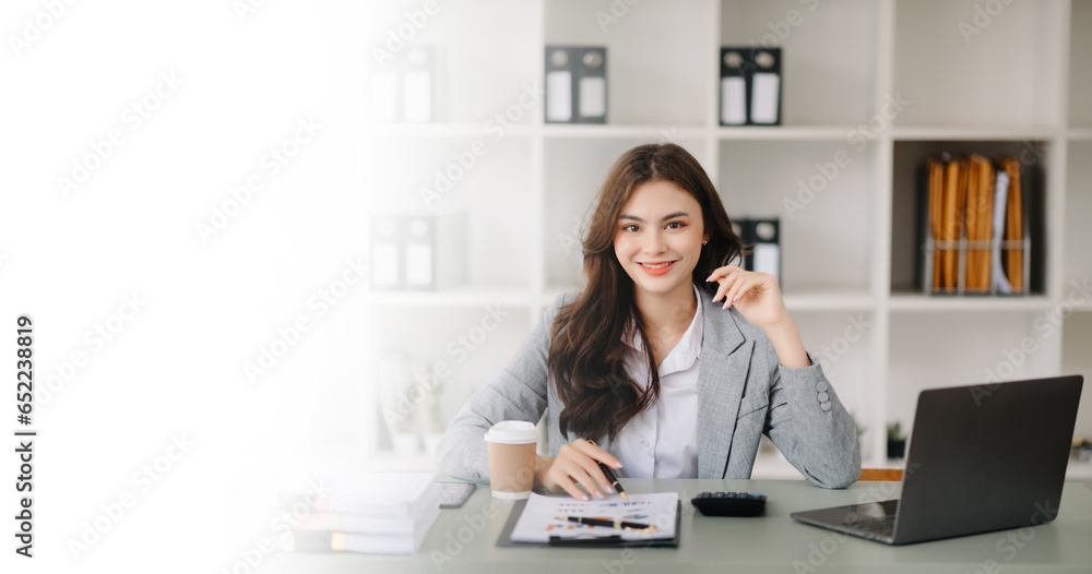 Confident business expert attractive smiling young woman holding digital tablet on desk in office.. Confident business expert attractive smiling young woman holding digital tablet on desk in office..