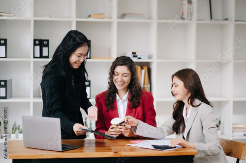 Office colleagues have a casual discussion. During a meeting in a conference room, a group of business teem sit in the conference room new startup project.