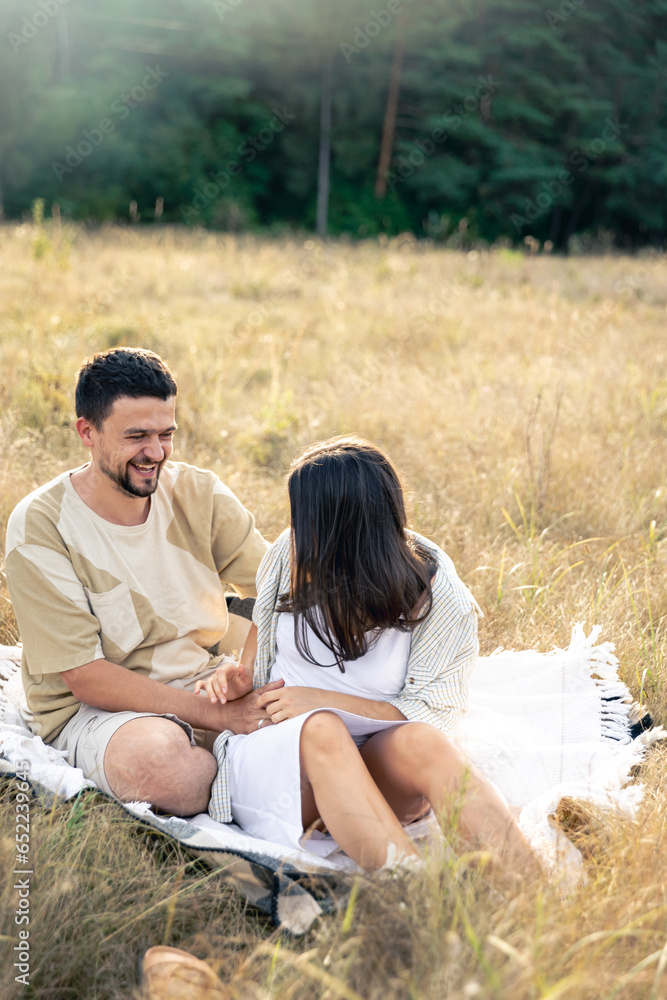 Happy married man and woman on a date relaxing in the field. Happy married man and woman on a date relaxing in the field.