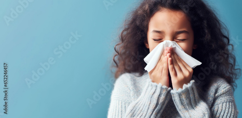 Innocent girl uses tissue, captured in a studio setting.