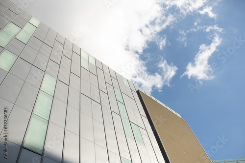 Low angle looking up at tall corporate glass building
