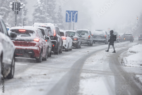 Traffic jam due to heavy snow and ice on the road photo