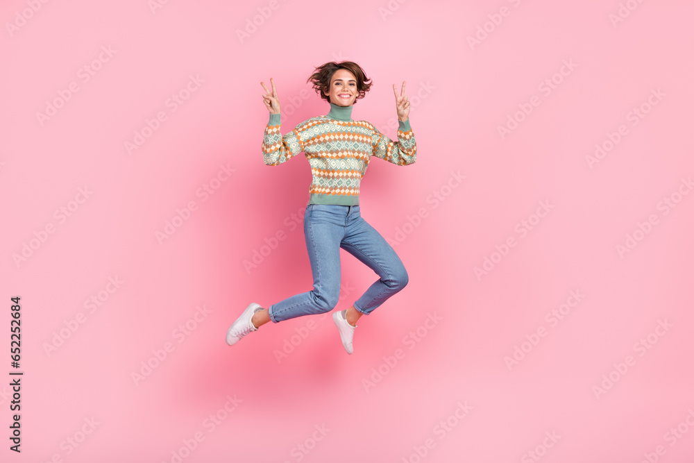 Full length picture of jumping funky girl bob brown hair showing two v sign symbols peace sportive isolated on pink color background Full length picture of jumping funky girl bob brown hair showing two v sign symbols peace sportive isolated on pink color background
