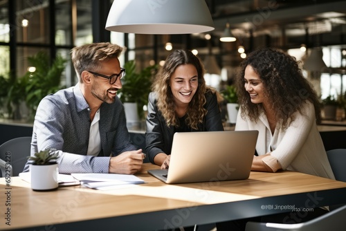 Creative businesspeople having a discussion using a laptop in an office