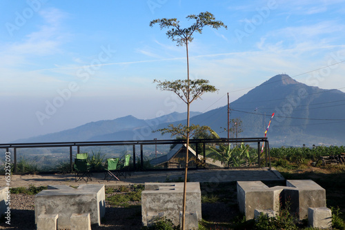 view of the peaks of several mountains at sunrise in the morning