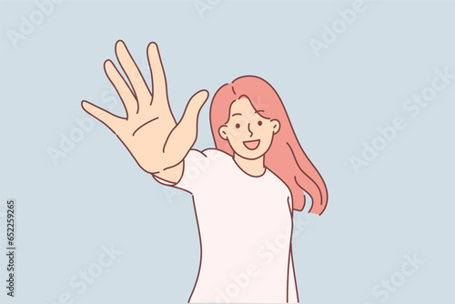 Happy woman holds out hand to screen and says hello and demonstrates number five with fingers