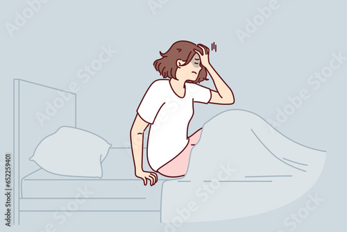Woman woke up with nightmare and sits in bed holding head, in need of sleeping pills or psychological support. Nightmare caused insomnia and headache in girl suffering from terrible dreams
