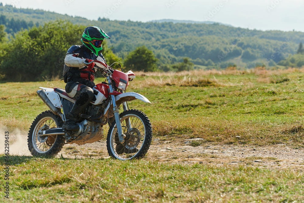 A professional motocross rider exhilaratingly riding a treacherous off-road forest trail on their motorcycle. A professional motocross rider exhilaratingly riding a treacherous off-road forest trail on their motorcycle.