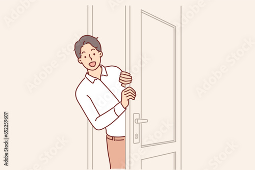 Man opens door and peeks into boss office, asking permission to enter and discuss work matters