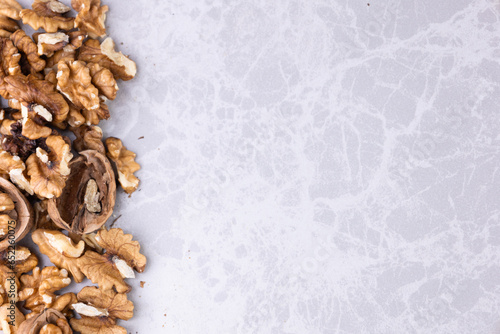 Background useable walnut standing on the edge of the marble counter photo