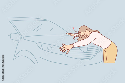 Woman hugs new car standing in car dealership and rejoicing in purchase of vehicle