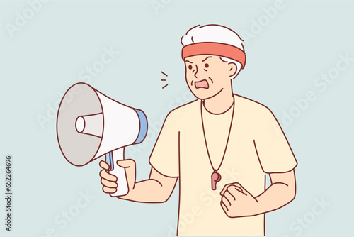Elderly coach with megaphone in hands nervously shouts out motivational words for athletes