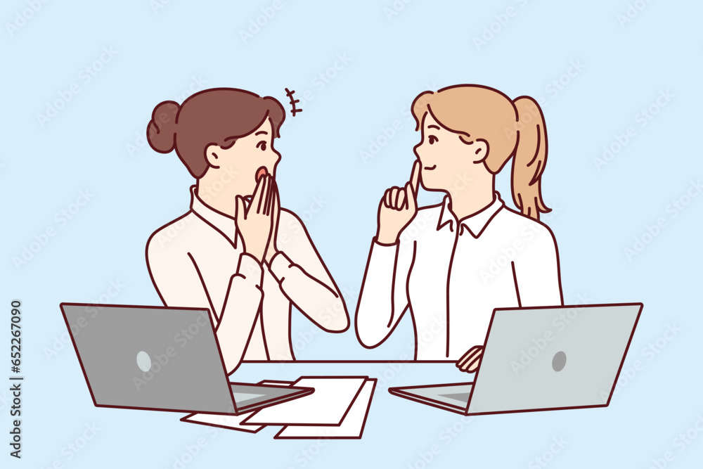 Woman office workers gossip and share secret forbidden for distribution, sitting at table with laptops and papers. Girls gossip and make shh sign forbidding data dissemination due to NDA contract Woman office workers gossip and share secret forbidden for distribution, sitting at table with laptops and papers. Girls gossip and make shh sign forbidding data dissemination due to NDA contract