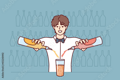Smiling bartender makes cocktail by pouring drinks from two bottles into one glass standing at bar counter. Man works in nightclub bar as bartender and comes up with new recipe for alcoholic drink.