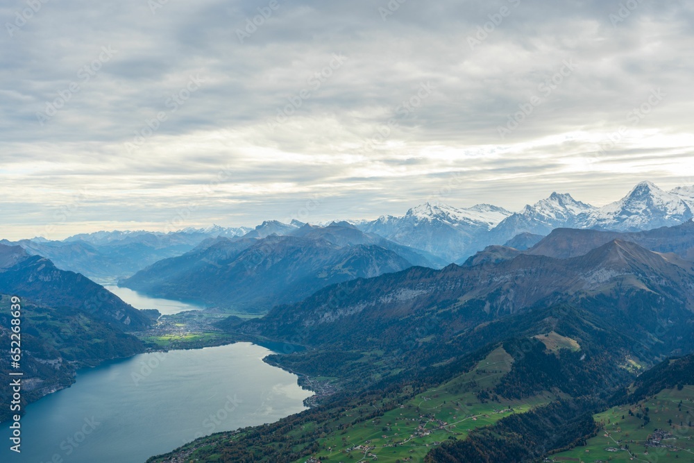 Views of the Bernese Oberland mountains with a cloudy sky the lake Thun and a layer of freshly snow