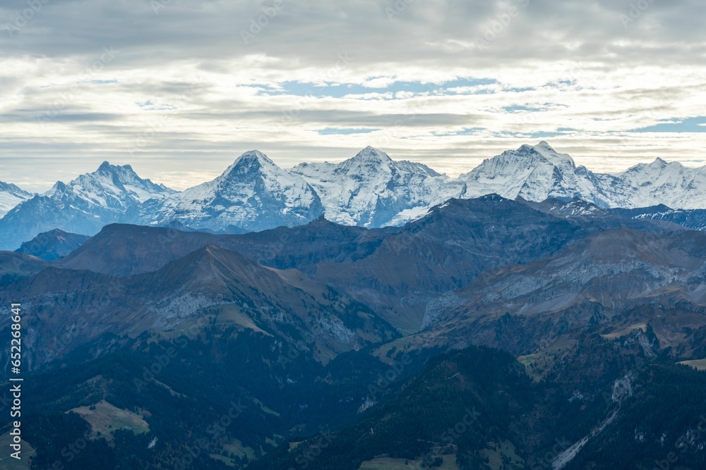 Breathtaking view of the Bernese Oberland mountains in Switzerland with a dramatic cloudy sky
