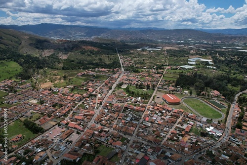 Aerial shot of a Colombian neighborhood with a group of houses and green field in El Cerrito