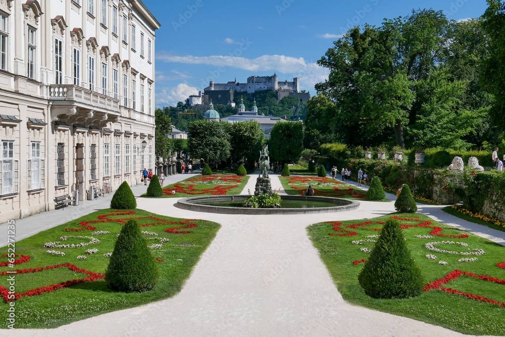 White building of Mirabell Palace and green garden