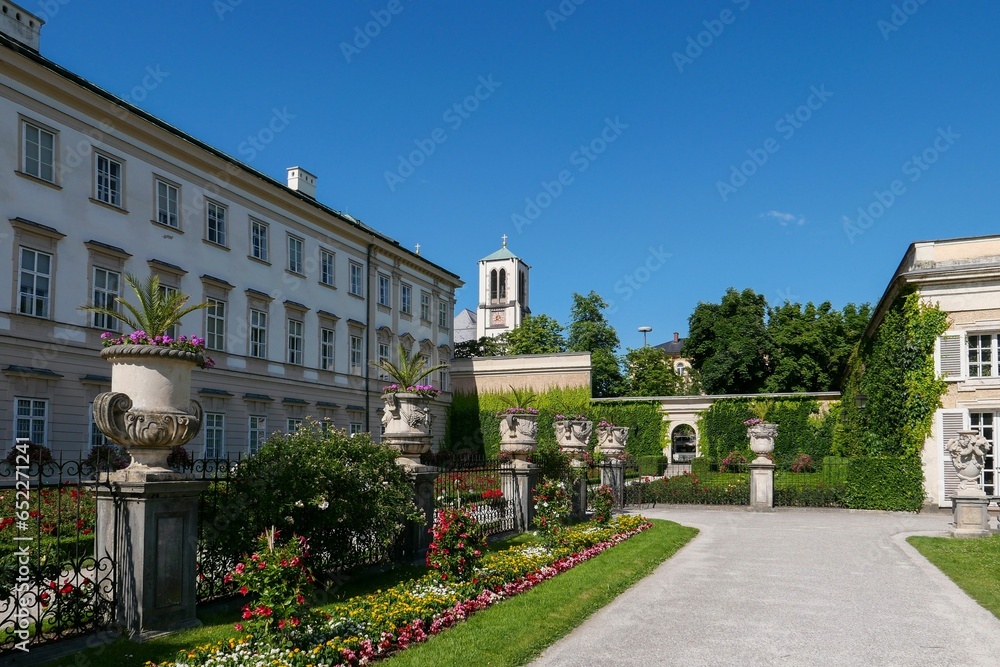 White building of Mirabell Palace and green garden