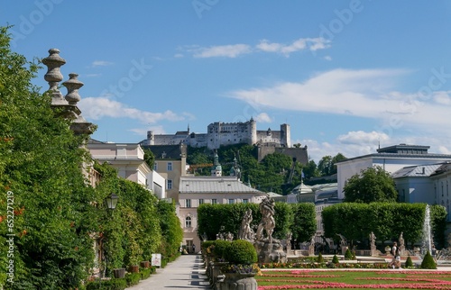 White building of Mirabell Palace and green garden