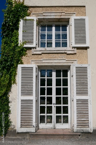 Wallpaper Mural Vertical shot of a wooden door and window with an open white shutters Torontodigital.ca