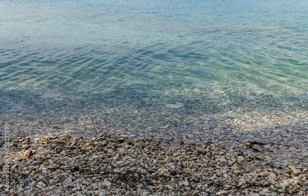 Closeup shot of a rocky coast with calm blue water - great for backgrounds Closeup shot of a rocky coast with calm blue water - great for backgrounds