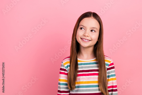 Photo of small charming kid girl kindergarten dreaming looking watching novelty party her friends isolated on pastel pink color background