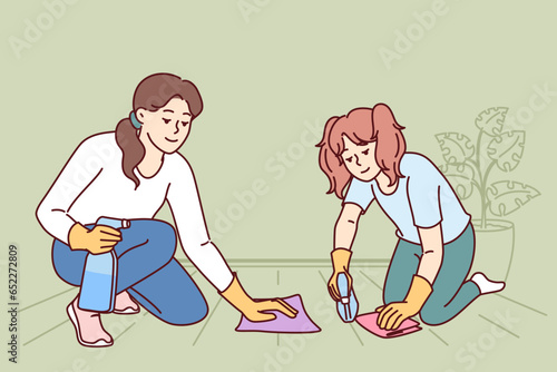 Mom and daughter are cleaning apartment together and washing floor using stain remover sprayer. Woman teaches child to do cleaning and household duties on own, taking care of girls future