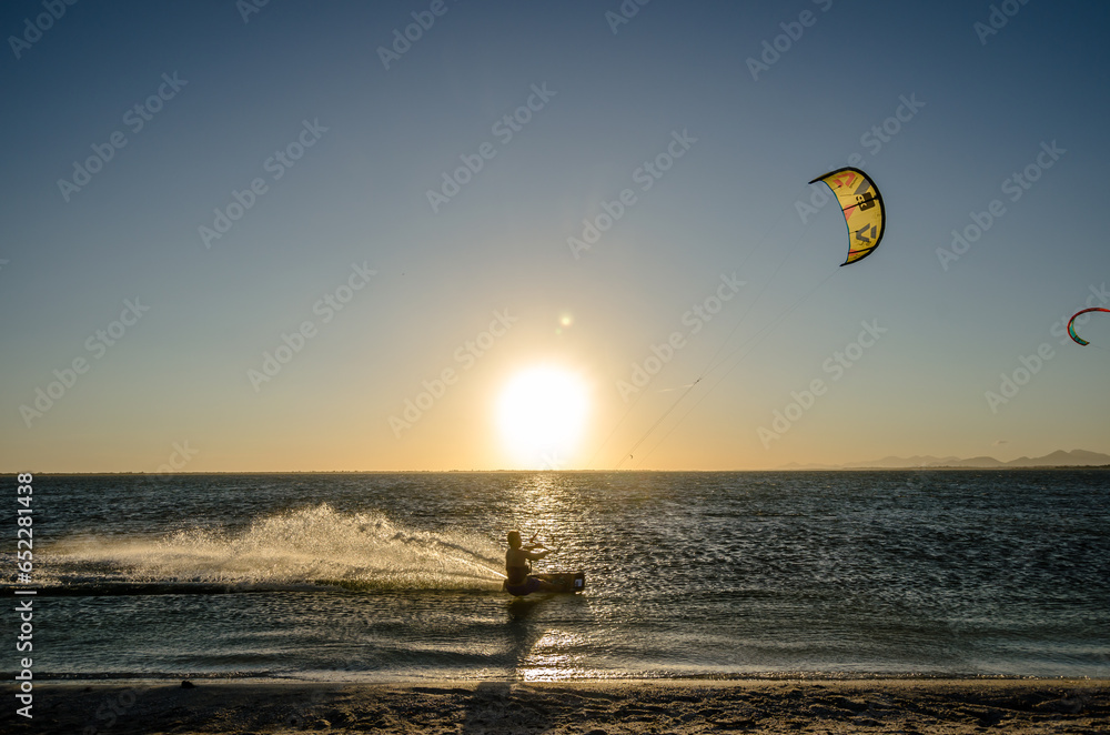 Scenic view of a tourist doing kite surfing in the sea Scenic view of a tourist doing kite surfing in the sea