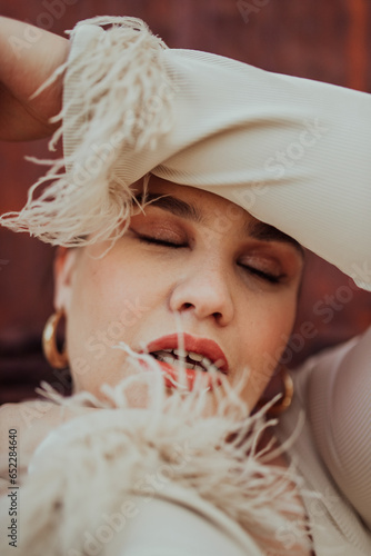 A close-up, unretouched portrait of a naturally beautiful young woman showcasing her authentic and unaltered facial features, capturing the essence of real beauty without any digital enhancements. photo