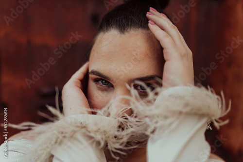 A close-up, unretouched portrait of a naturally beautiful young woman showcasing her authentic and unaltered facial features, capturing the essence of real beauty without any digital enhancements. photo