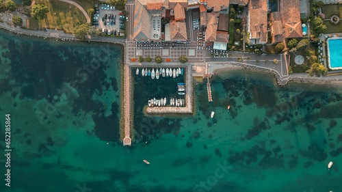 View of the picturesque turquoise waters of Cisano Harbour in Bardolino  Italy