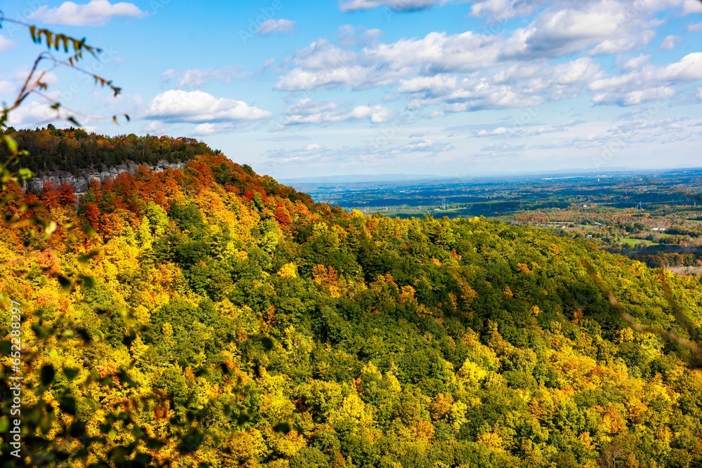 Landscape scene of green mountains and trees in Thacher State Park with blue sky