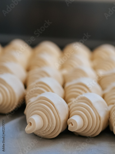Raw croissants in production in a bakery close-up
