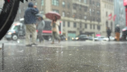 Rainy day in New York city. 4K wide angle video during a powerful rain in Manhattan with people with umbrellas crossing the street. Summer storm in America.