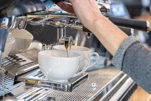 Barista coffee service concept.Barista women using coffee machine to make coffee in cafe