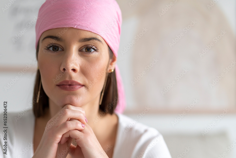Beautiful woman posing with a pink veil on her head claiming the fight against cancer Beautiful woman posing with a pink veil on her head claiming the fight against cancer