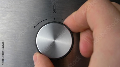 Adjusting Electric Oven Temperature by Turning the Oven Switch Close Up
